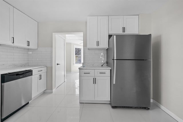 kitchen with white cabinetry, baseboards, and stainless steel appliances