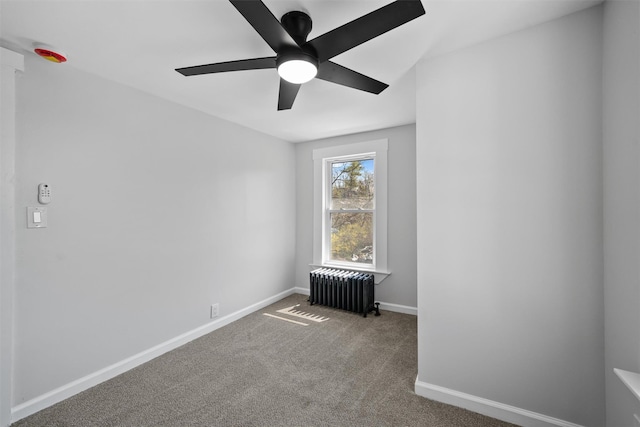 unfurnished room with radiator, carpet, baseboards, and ceiling fan