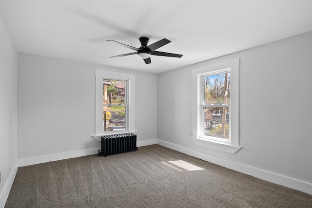 unfurnished room with radiator heating unit, a healthy amount of sunlight, carpet floors, and ceiling fan