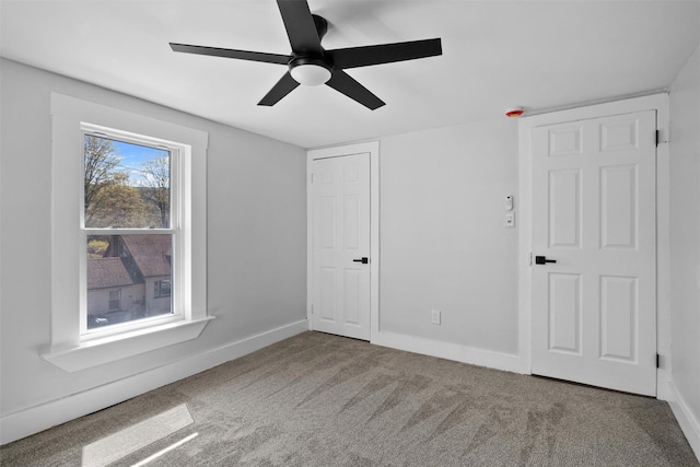 unfurnished bedroom with carpet, baseboards, and ceiling fan