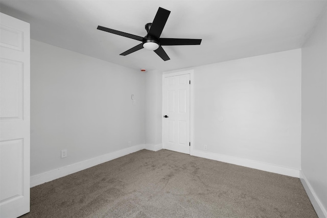 spare room featuring baseboards, carpet floors, and ceiling fan