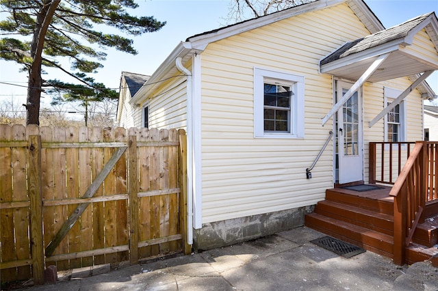 129 Locust Dr, Mastic Beach, NY 11951 - view of side of home featuring fence and a patio