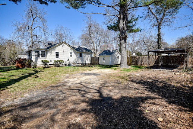 129 Locust Dr, Mastic Beach, NY 11951 - view of side of property featuring an outdoor structure, a shed, and driveway