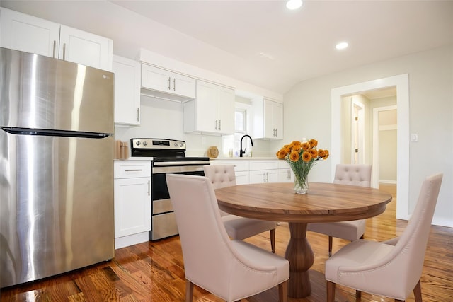 129 Locust Dr, Mastic Beach, NY 11951 - kitchen featuring appliances with stainless steel finishes, light countertops, white cabinets, recessed lighting, and dark wood-style flooring