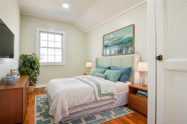 129 Locust Dr, Mastic Beach, NY 11951 - bedroom featuring wood finished floors, ornamental molding, lofted ceiling, baseboards, and recessed lighting