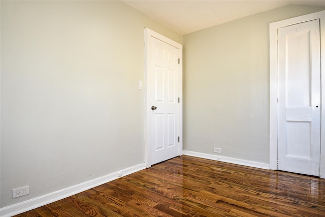 129 Locust Dr, Mastic Beach, NY 11951 - unfurnished bedroom featuring dark wood-style flooring, baseboards, and vaulted ceiling