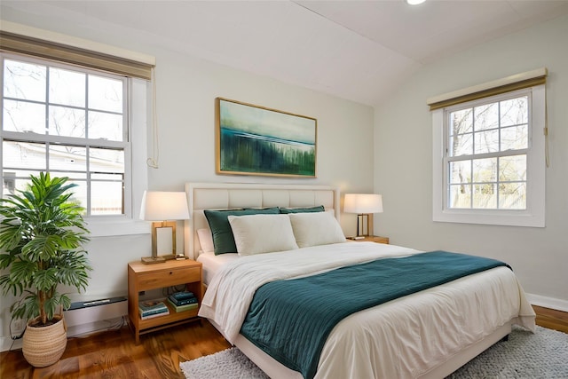 129 Locust Dr, Mastic Beach, NY 11951 - bedroom with wood finished floors, lofted ceiling, a baseboard radiator, and baseboards