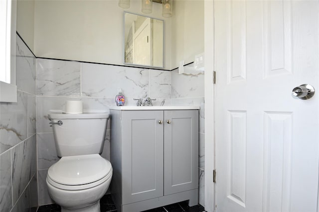 129 Locust Dr, Mastic Beach, NY 11951 - half bathroom featuring tile walls, toilet, and vanity