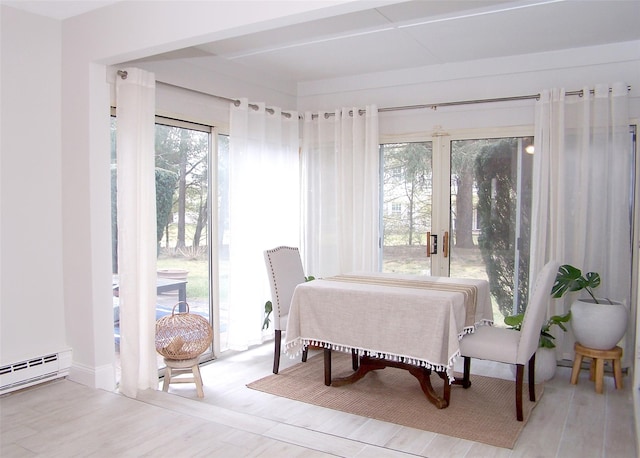 16 Hearthside Dr, Mount Sinai, NY 11766 - dining area featuring a baseboard radiator and wood finished floors