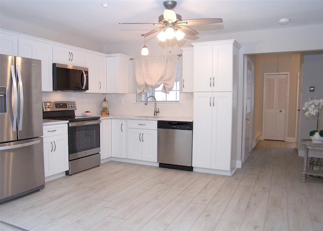 16 Hearthside Dr, Mount Sinai, NY 11766 - kitchen featuring white cabinets, a sink, a ceiling fan, light countertops, and appliances with stainless steel finishes