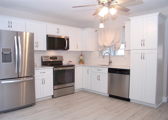 16 Hearthside Dr, Mount Sinai, NY 11766 - kitchen featuring white cabinets, light countertops, backsplash, a sink, and appliances with stainless steel finishes