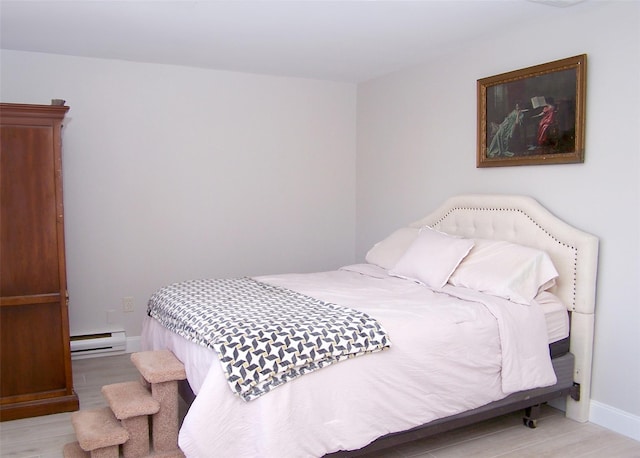16 Hearthside Dr, Mount Sinai, NY 11766 - bedroom with baseboards, baseboard heating, and wood finished floors