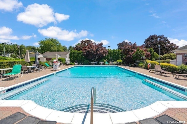 16 Hearthside Dr, Mount Sinai, NY 11766 - community pool with a patio area and fence