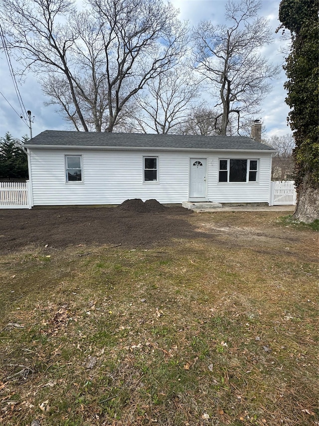 view of front of home with fence and a chimney