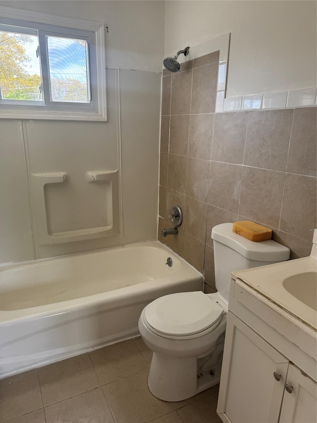 full bath featuring shower / tub combination, tile patterned flooring, vanity, toilet, and tile walls