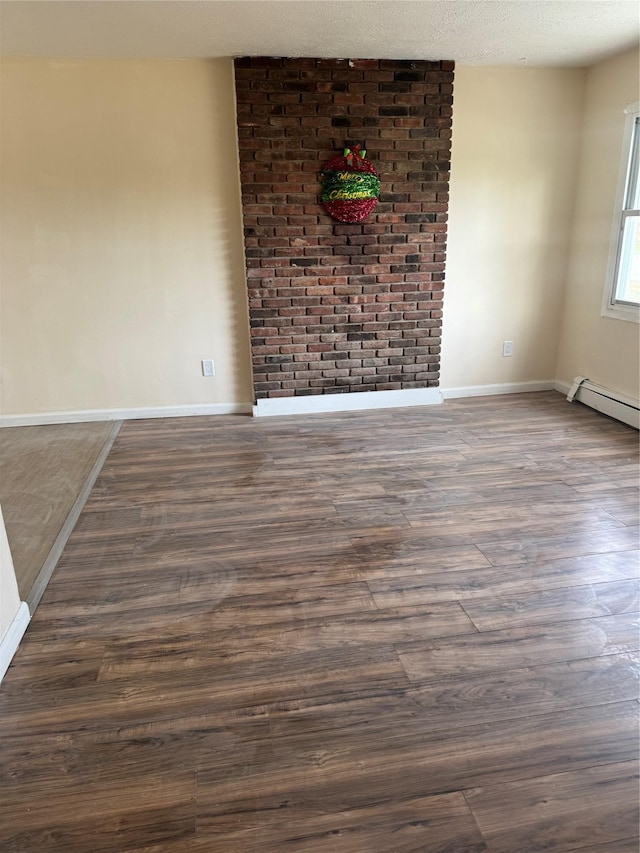 empty room with baseboards, a baseboard radiator, and dark wood-style floors