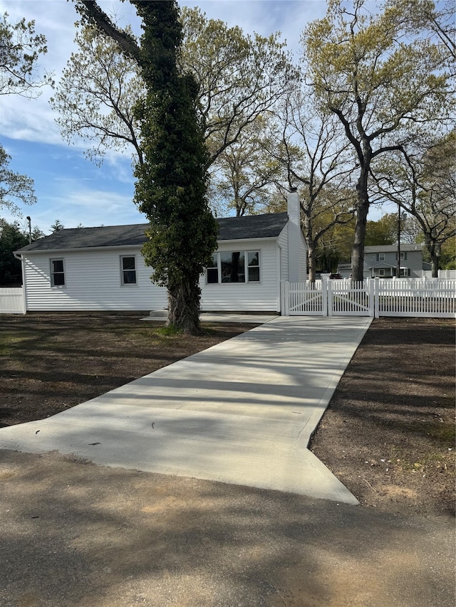 view of front of home featuring fence and a chimney