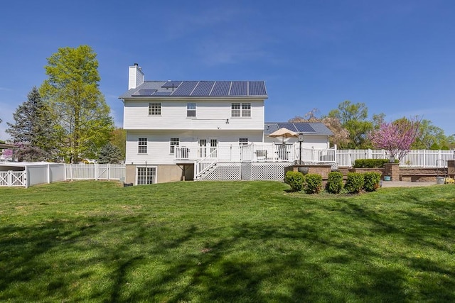 17 Frances Ln, Monroe, NY 10950 - rear view of property with a deck, a fenced backyard, roof mounted solar panels, a lawn, and stairway