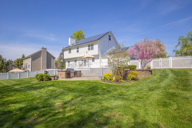 17 Frances Ln, Monroe, NY 10950 - back of property with a lawn, fence, a chimney, and metal roof