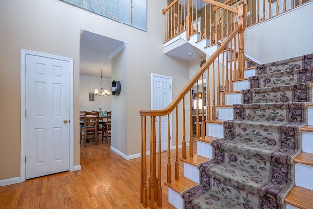 17 Frances Ln, Monroe, NY 10950 - stairway with a high ceiling, a notable chandelier, baseboards, and hardwood / wood-style floors