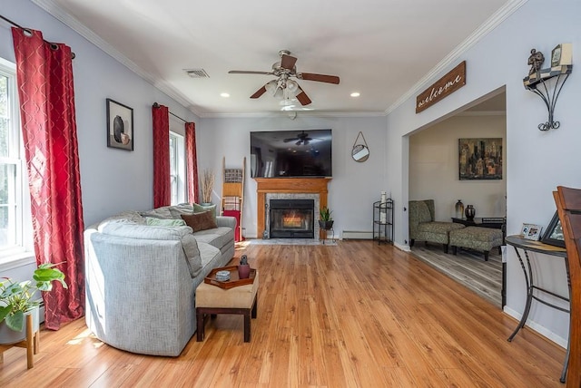 17 Frances Ln, Monroe, NY 10950 - living room featuring a ceiling fan, visible vents, a fireplace with flush hearth, ornamental molding, and light wood-style flooring