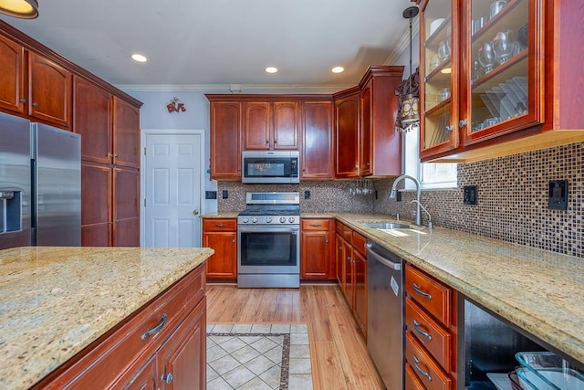 17 Frances Ln, Monroe, NY 10950 - kitchen featuring ornamental molding, glass insert cabinets, light stone counters, a sink, and appliances with stainless steel finishes