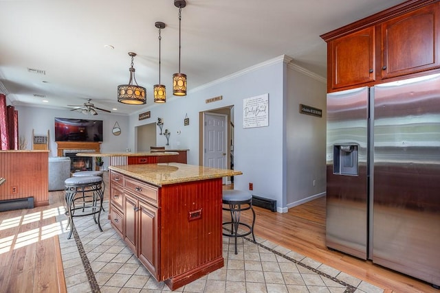 17 Frances Ln, Monroe, NY 10950 - kitchen featuring ceiling fan, a kitchen bar, a center island, stainless steel fridge, and ornamental molding