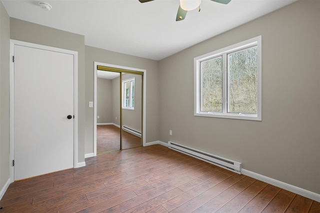 242 Callicoon Center Rd, Jeffersonville, NY 12748 - unfurnished bedroom with wood-type flooring, a closet, baseboards, and a baseboard radiator