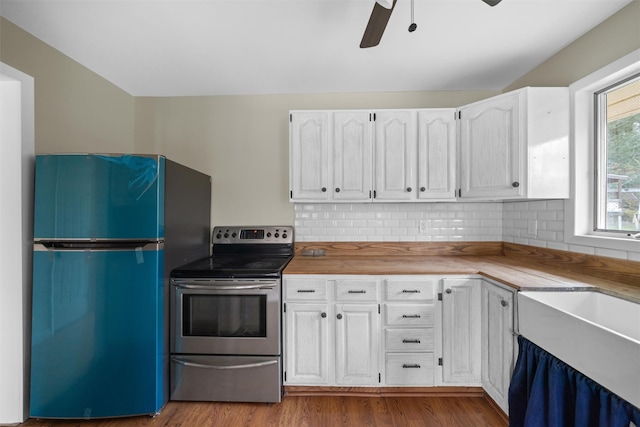 242 Callicoon Center Rd, Jeffersonville, NY 12748 - kitchen with electric stove, white cabinetry, freestanding refrigerator, dark wood-style floors, and a ceiling fan