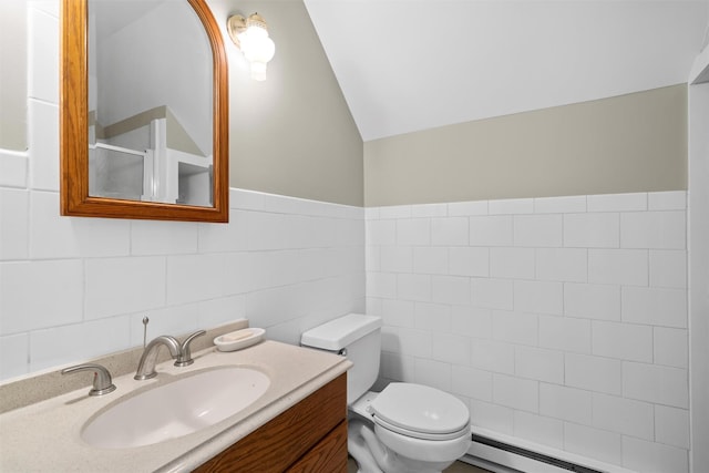 242 Callicoon Center Rd, Jeffersonville, NY 12748 - bathroom featuring tile walls, vanity, toilet, baseboard heating, and lofted ceiling