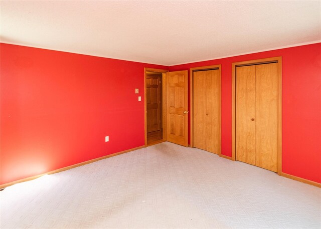 295 Overhill Rd, Stormville, NY 12582 - unfurnished bedroom with two closets, carpet floors, and baseboards
