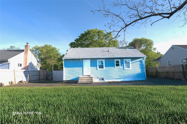 23 Cumberbach St, Wyandanch, NY 11798 - rear view of house featuring a lawn, fence private yard, and entry steps
