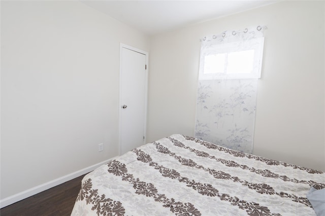 23 Cumberbach St, Wyandanch, NY 11798 - bedroom with baseboards and dark wood-style flooring