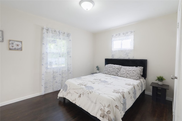 23 Cumberbach St, Wyandanch, NY 11798 - bedroom with baseboards and dark wood-style floors