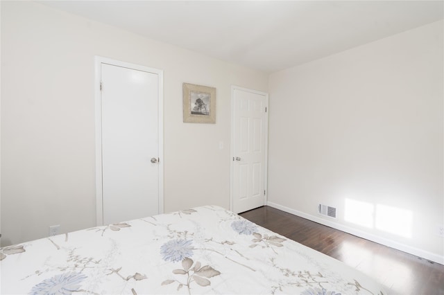 23 Cumberbach St, Wyandanch, NY 11798 - bedroom featuring baseboards, dark wood-style flooring, and visible vents