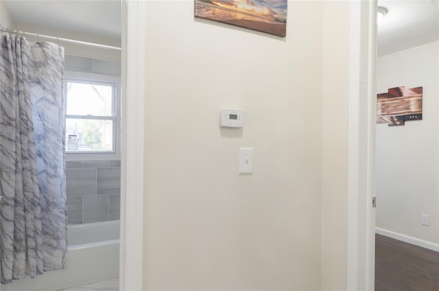 23 Cumberbach St, Wyandanch, NY 11798 - bathroom featuring baseboards, shower / bath combination with curtain, and wood finished floors