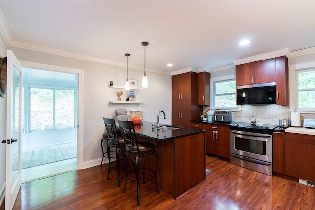 69 Taylor Rd, Patterson, NY 12563 - kitchen with stainless steel appliances, a sink, dark countertops, a peninsula, and dark wood-style floors