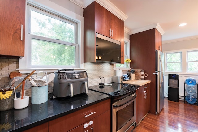 69 Taylor Rd, Patterson, NY 12563 - kitchen with stainless steel appliances, decorative backsplash, light wood-style flooring, ornamental molding, and dark stone counters