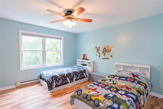 69 Taylor Rd, Patterson, NY 12563 - bedroom with a baseboard radiator, wood finished floors, and a ceiling fan