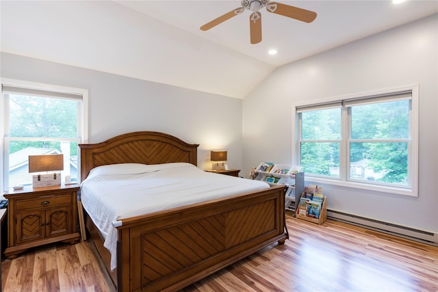 69 Taylor Rd, Patterson, NY 12563 - bedroom with lofted ceiling, a baseboard heating unit, light wood-type flooring, multiple windows, and recessed lighting