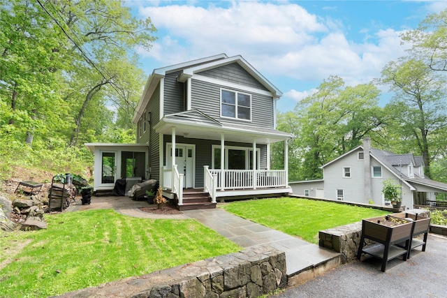 69 Taylor Rd, Patterson, NY 12563 - view of front of property featuring an outdoor fire pit, a porch, and a front lawn
