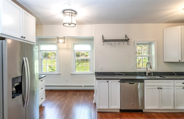 78 Closter Rd, Palisades, NY 10964 - kitchen featuring dark countertops, appliances with stainless steel finishes, baseboard heating, a sink, and white cabinetry