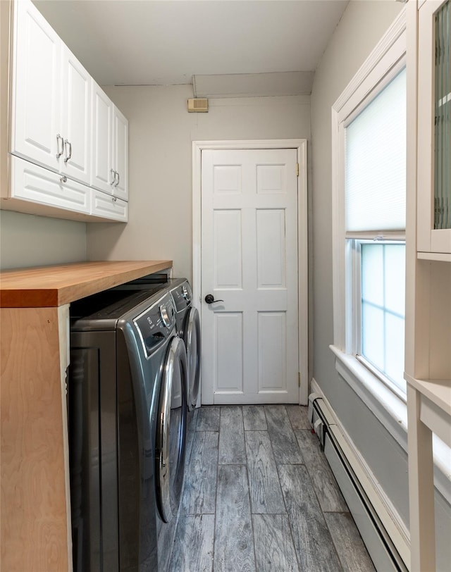 78 Closter Rd, Palisades, NY 10964 - laundry area with separate washer and dryer, a baseboard heating unit, cabinet space, and wood finished floors