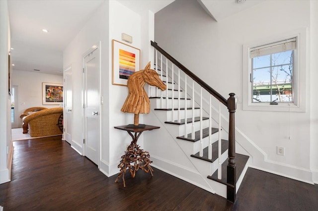 stairs with baseboards and wood finished floors
