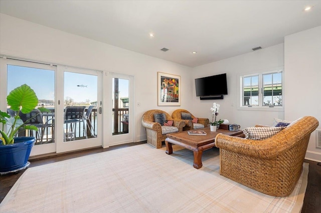 living area featuring recessed lighting and visible vents