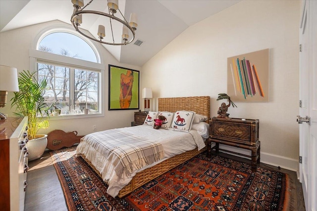 bedroom with vaulted ceiling, wood finished floors, a chandelier, baseboards, and visible vents