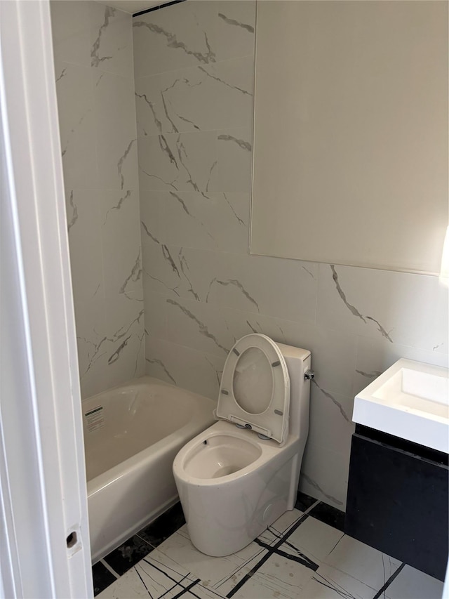67 2nd St W, Mount Vernon, NY 10550 - full bath with marble finish floor, toilet, vanity, and tile walls