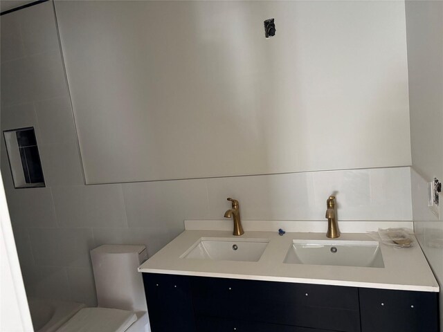 67 2nd St W, Mount Vernon, NY 10550 - full bath with double vanity, toilet, tile walls, and a sink