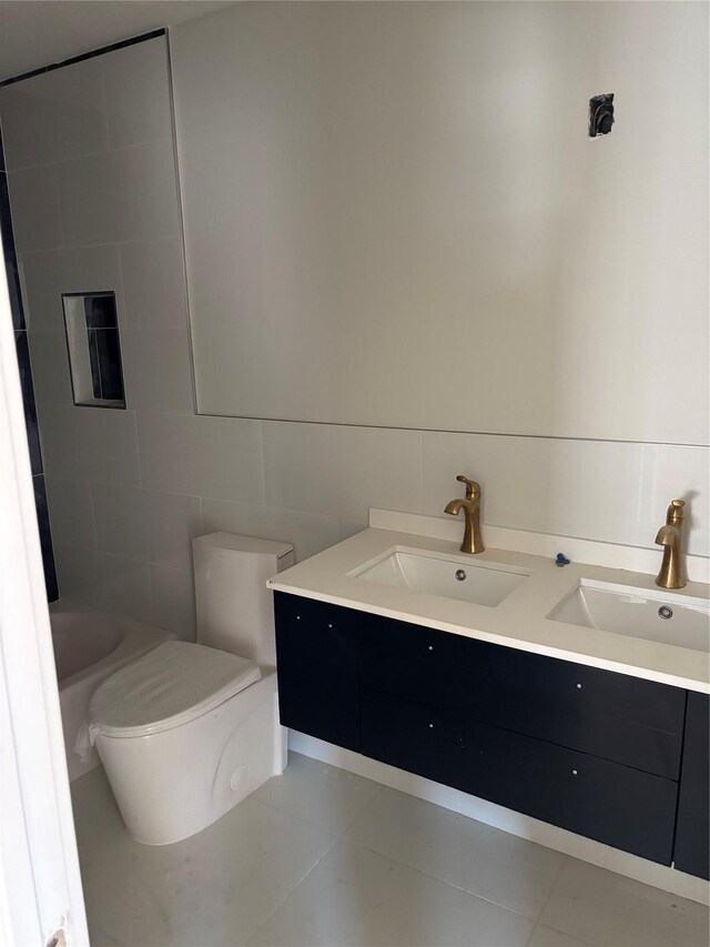 67 2nd St W, Mount Vernon, NY 10550 - full bathroom featuring tile walls, a sink, double vanity, and toilet