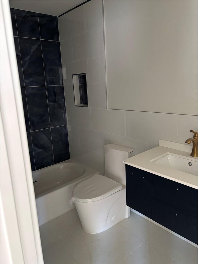 67 2nd St W, Mount Vernon, NY 10550 - full bathroom with bathing tub / shower combination, toilet, tile walls, tile patterned flooring, and vanity